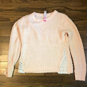 Pink sweater with white crochet detail on sides